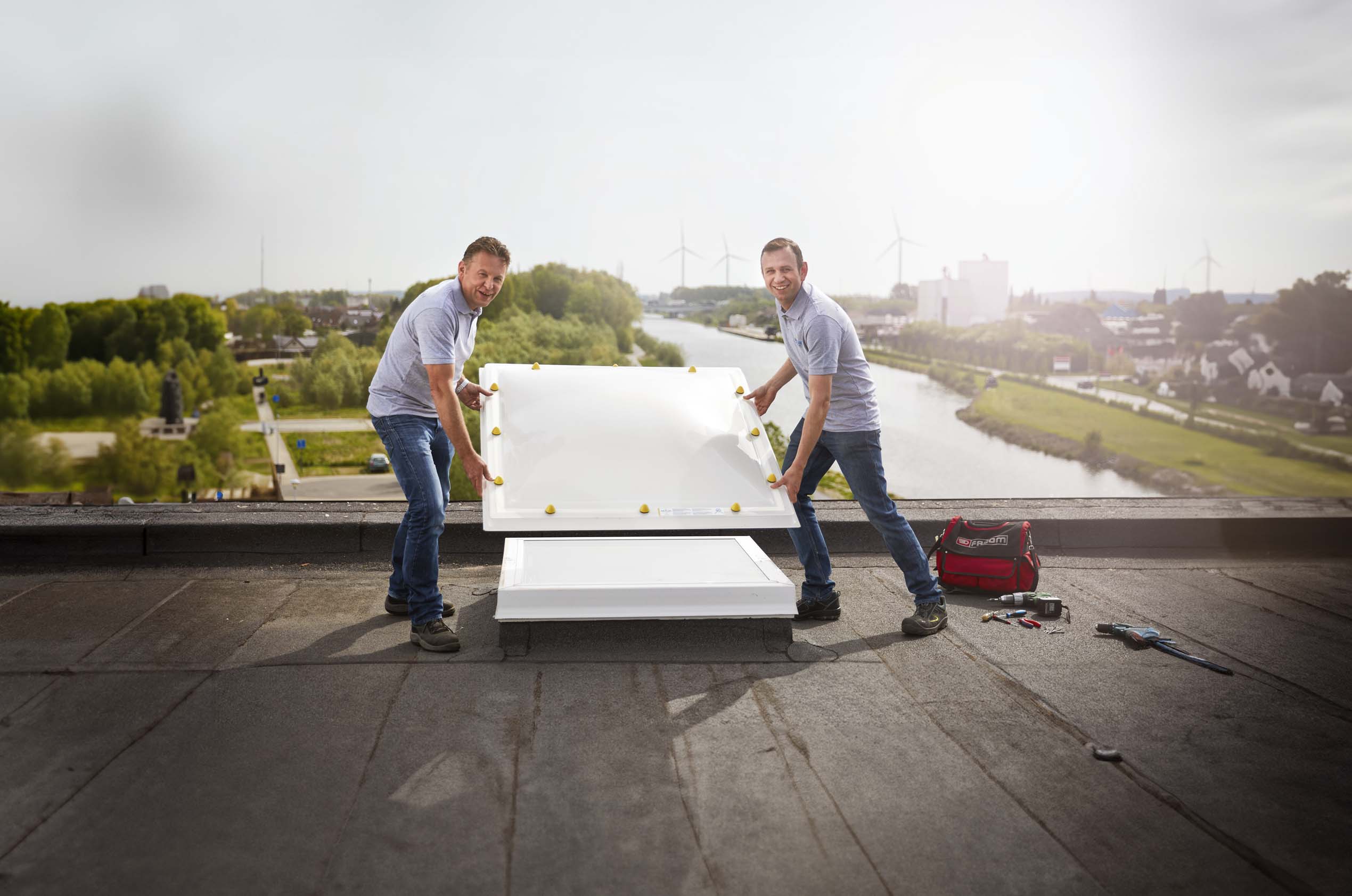 Professional_installation_of_a_Skylux_dome_skylight_on_a_flat_roof
